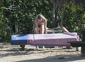 Supermodel Kate Moss sunbathing topless