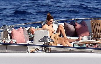 Katharine McPhee sunbathing topless on a yacht in Capri