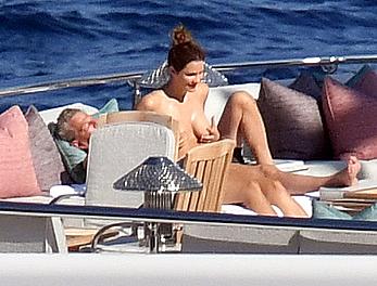 Katharine McPhee sunbathing topless on a yacht in Capri