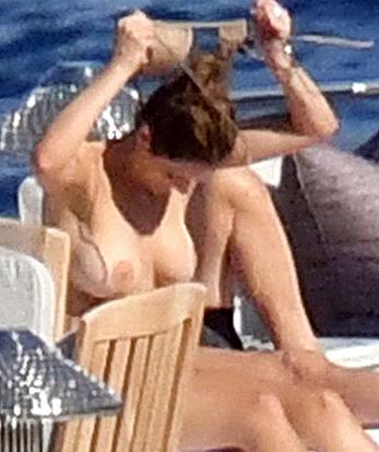 Katharine McPhee sunbathing topless on a yacht in Capri