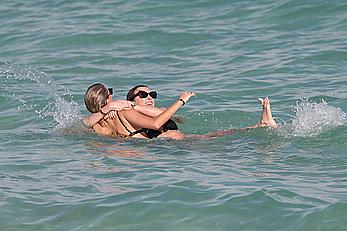 Katie Cassidy in bikini on the beach with friends