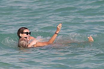 Katie Cassidy in bikini on the beach with friends