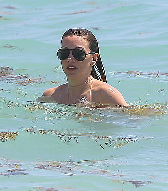 Katie Cassidy in red bikini on the beach candids