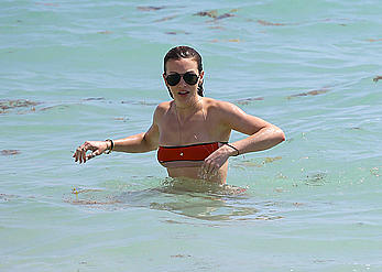 Katie Cassidy in red bikini on the beach candids