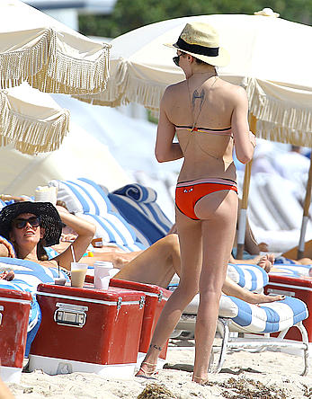 Katie Cassidy in red bikini on the beach candids