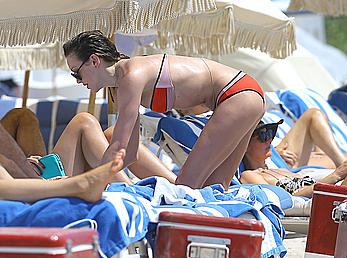 Katie Cassidy in red bikini on the beach candids