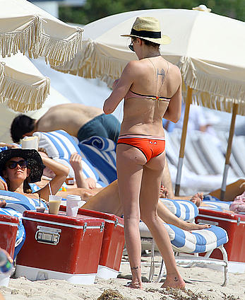 Katie Cassidy in red bikini on the beach candids