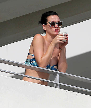 Katy Perry wearing a bikini top on a hotel balcony in Miami