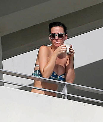 Katy Perry wearing a bikini top on a hotel balcony in Miami