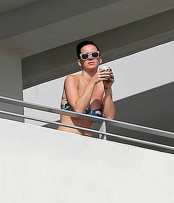 Katy Perry wearing a bikini top on a hotel balcony in Miami