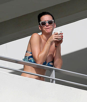 Katy Perry wearing a bikini top on a hotel balcony in Miami