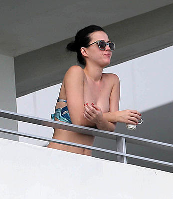 Katy Perry wearing a bikini top on a hotel balcony in Miami