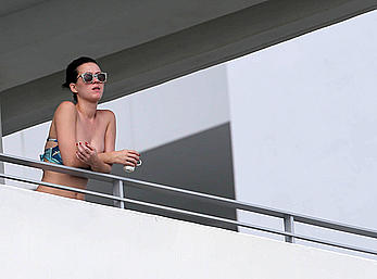 Katy Perry wearing a bikini top on a hotel balcony in Miami