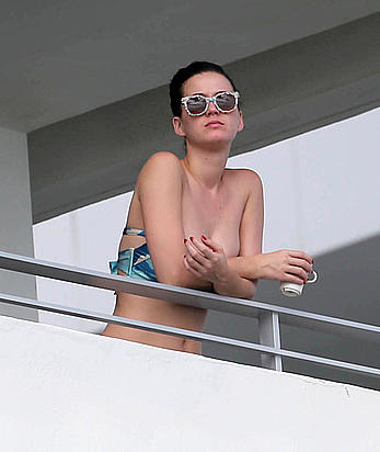 Katy Perry wearing a bikini top on a hotel balcony in Miami