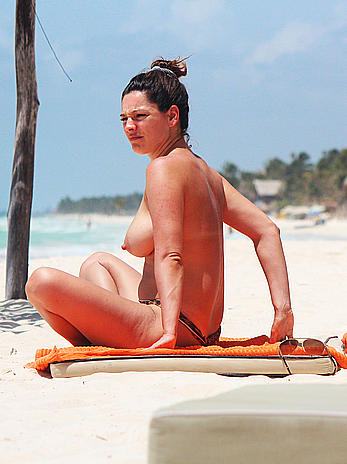 Kelly Brook caught topless on the beach in Cancun