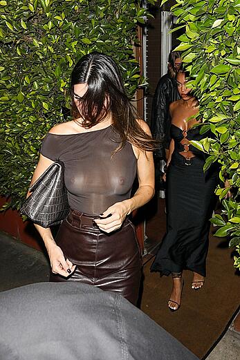 Kendall Jenner in a sheer top & leather skirt going out for dinner with friends