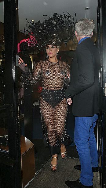 Lady Gaga topless with pasties under fishnet dress in London