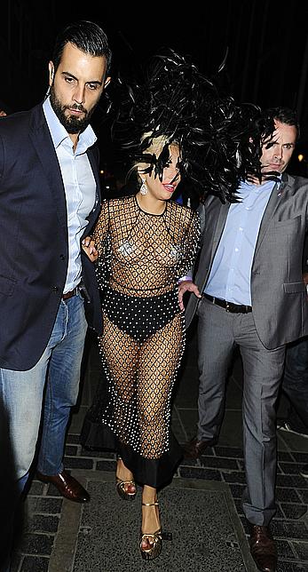 Lady Gaga topless with pasties under fishnet dress in London