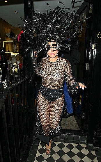 Lady Gaga topless with pasties under fishnet dress in London