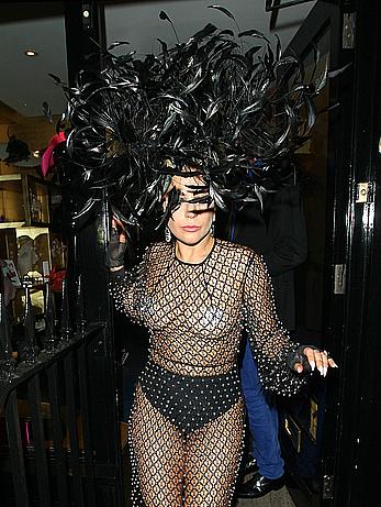 Lady Gaga topless with pasties under fishnet dress in London