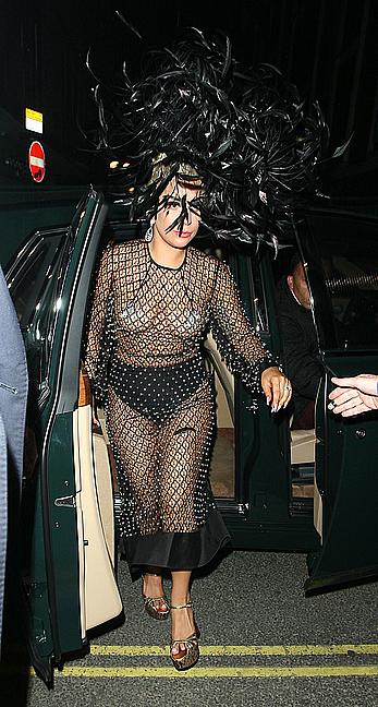 Lady Gaga topless with pasties under fishnet dress in London