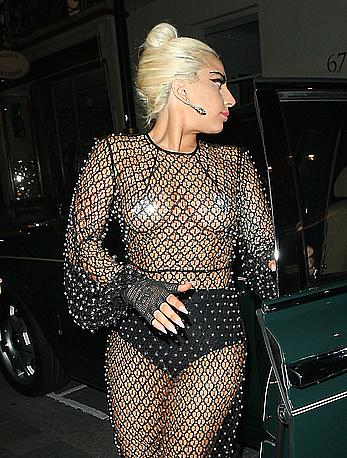 Lady Gaga topless with pasties under fishnet dress in London