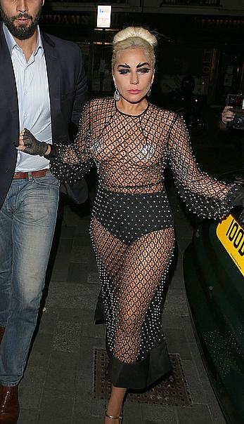 Lady Gaga topless with pasties under fishnet dress in London