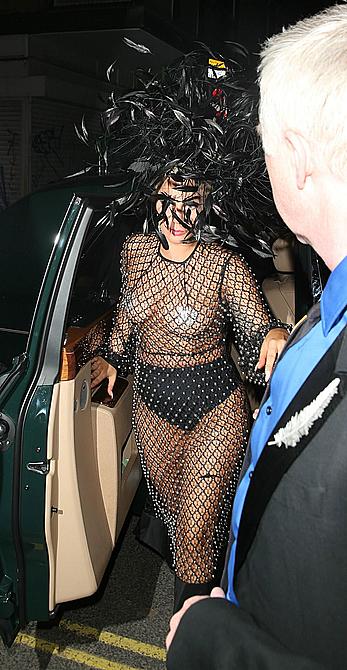 Lady Gaga topless with pasties under fishnet dress in London