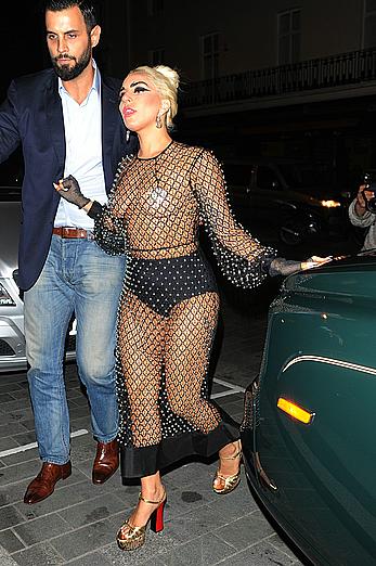 Lady Gaga topless with pasties under fishnet dress in London