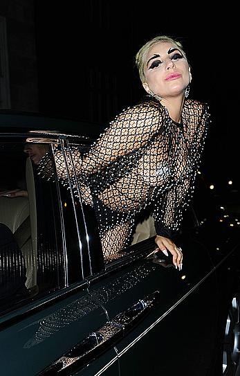 Lady Gaga topless with pasties under fishnet dress in London