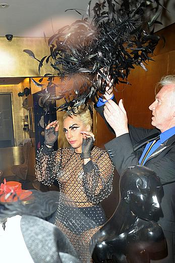 Lady Gaga topless with pasties under fishnet dress in London