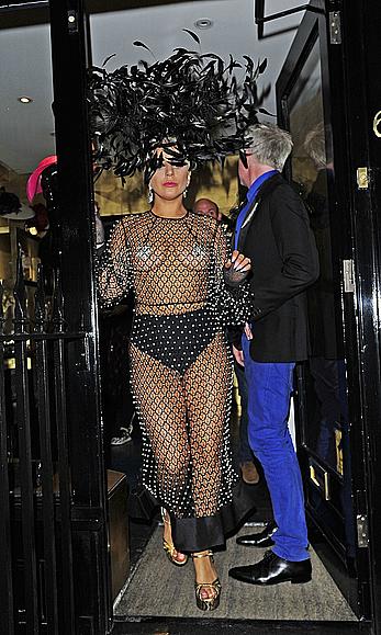 Lady Gaga topless with pasties under fishnet dress in London