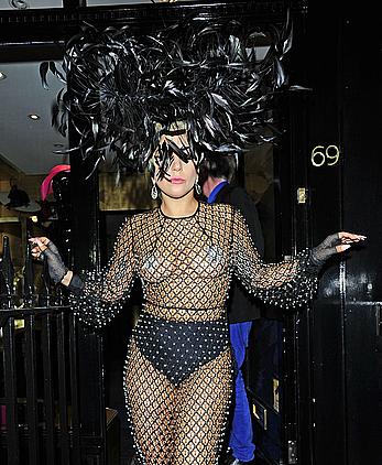 Lady Gaga topless with pasties under fishnet dress in London