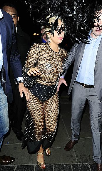 Lady Gaga topless with pasties under fishnet dress in London