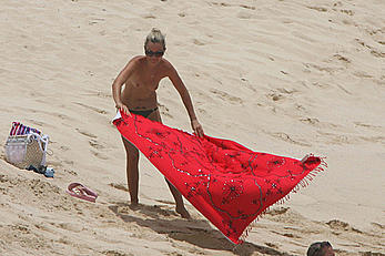 Laeticia Hallyday tanning topless on a beach