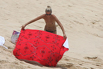 Laeticia Hallyday tanning topless on a beach