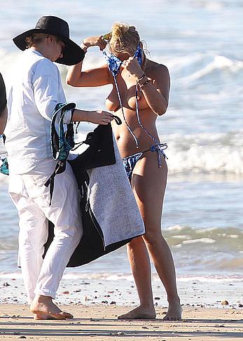 Lara Bingle topless on a beach during photosession