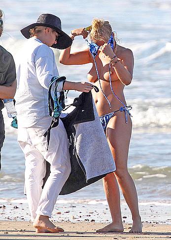 Lara Bingle topless on a beach during photosession