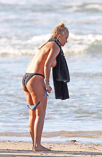 Lara Bingle topless on a beach during photosession