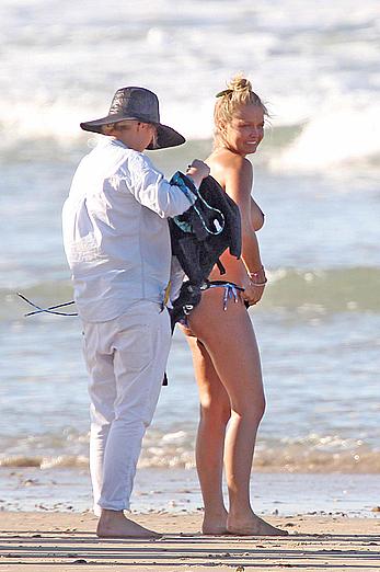 Lara Bingle topless on a beach during photosession