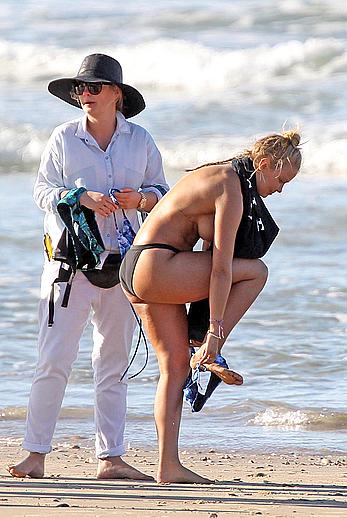 Lara Bingle topless on a beach during photosession