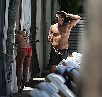 Lauren Stoner in red bikini poolside in Miami