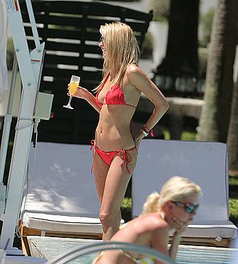 Lauren Stoner in red bikini poolside in Miami