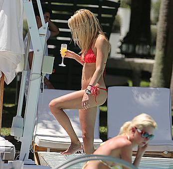 Lauren Stoner in red bikini poolside in Miami