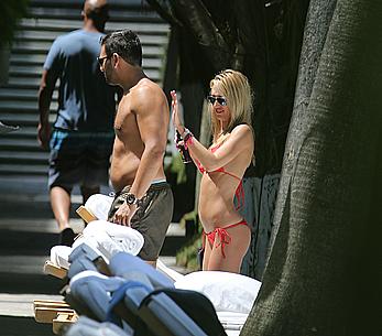 Lauren Stoner in red bikini poolside in Miami