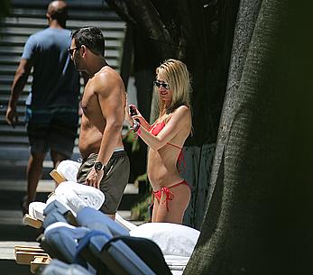 Lauren Stoner in red bikini poolside in Miami