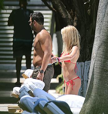 Lauren Stoner in red bikini poolside in Miami