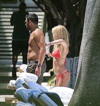 Lauren Stoner in red bikini poolside in Miami