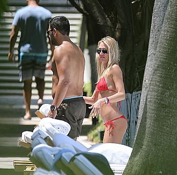 Lauren Stoner in red bikini poolside in Miami