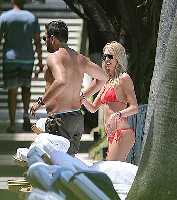 Lauren Stoner in red bikini poolside in Miami